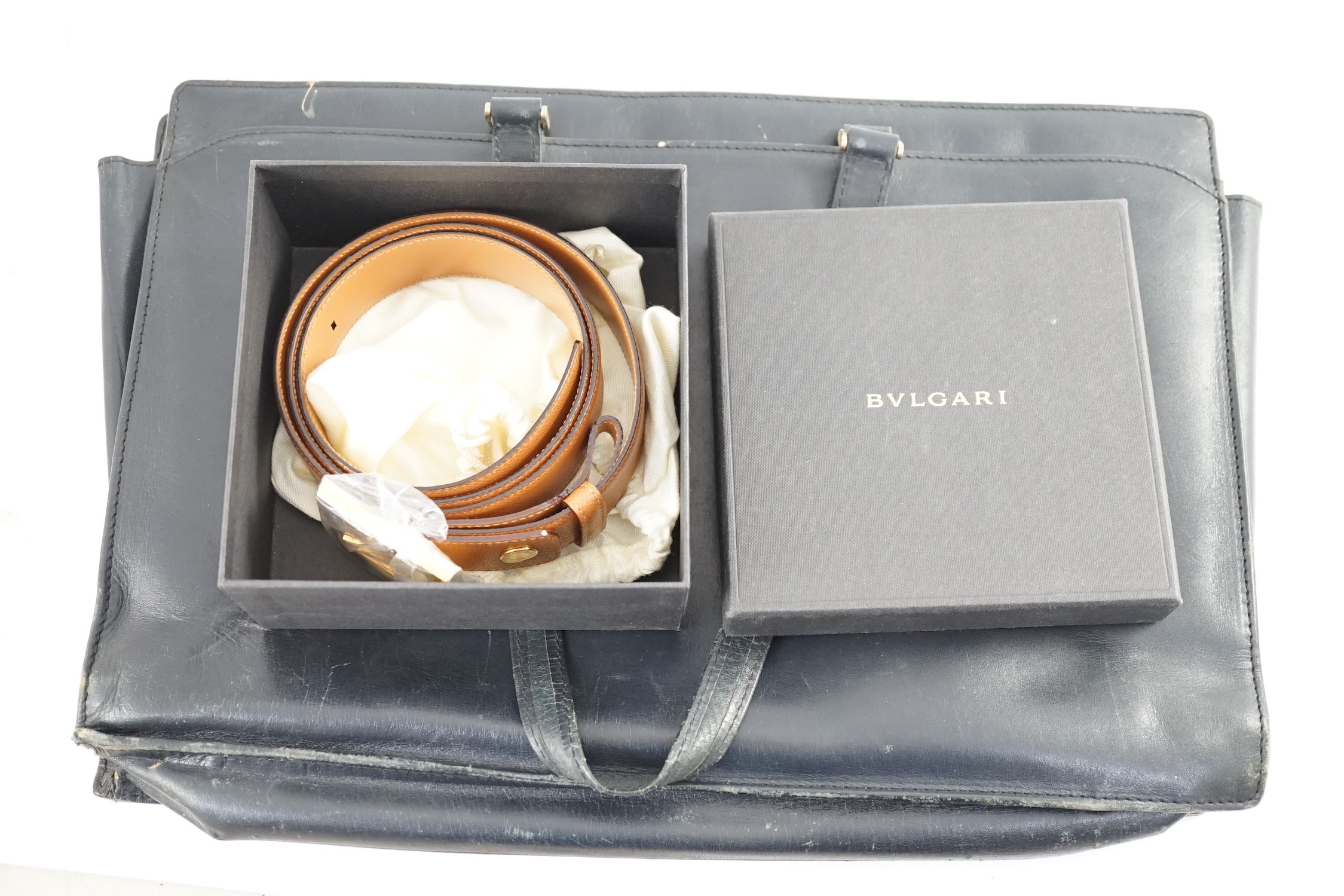 A Bulgari tan leather belt (unused), 115 cm, boxed with bag and a worn Asprey black leather attaché case